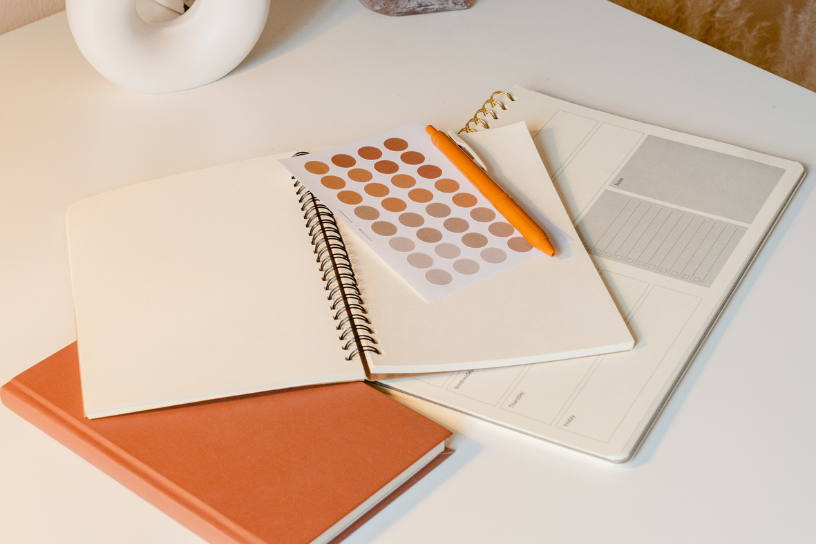 Notebooks and Stickers on White Study Desk